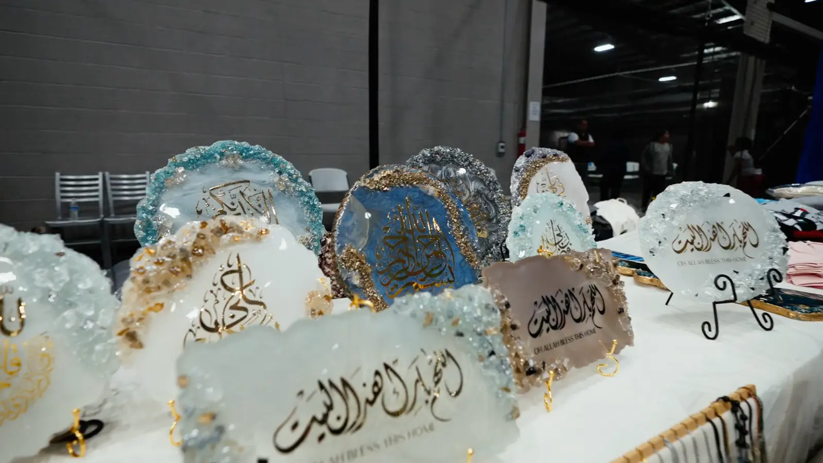 Handmade calligraphy pieces on a bazaar table